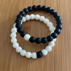 Black and white Lokai bracelets